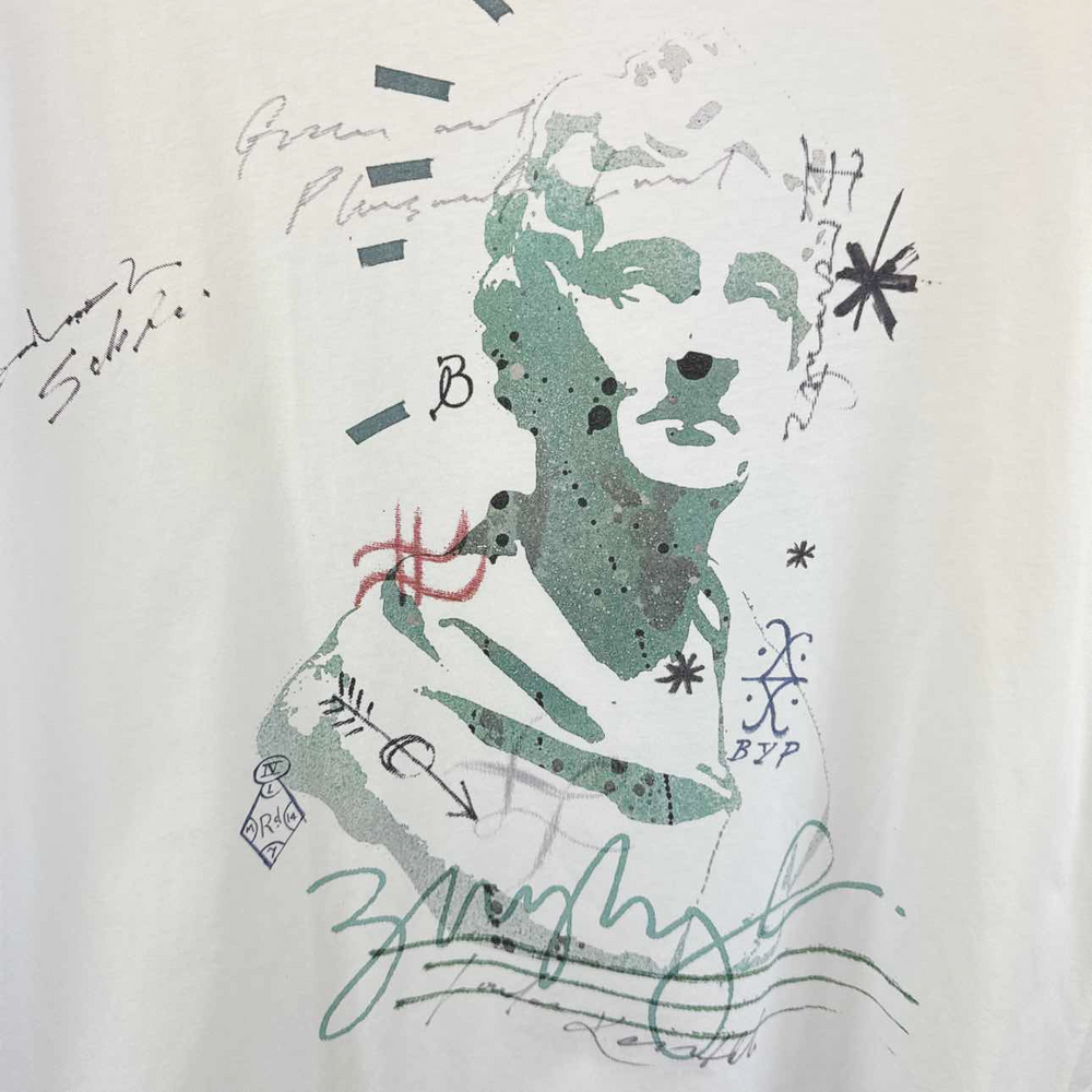 a white t - shirt with a drawing of a man's face