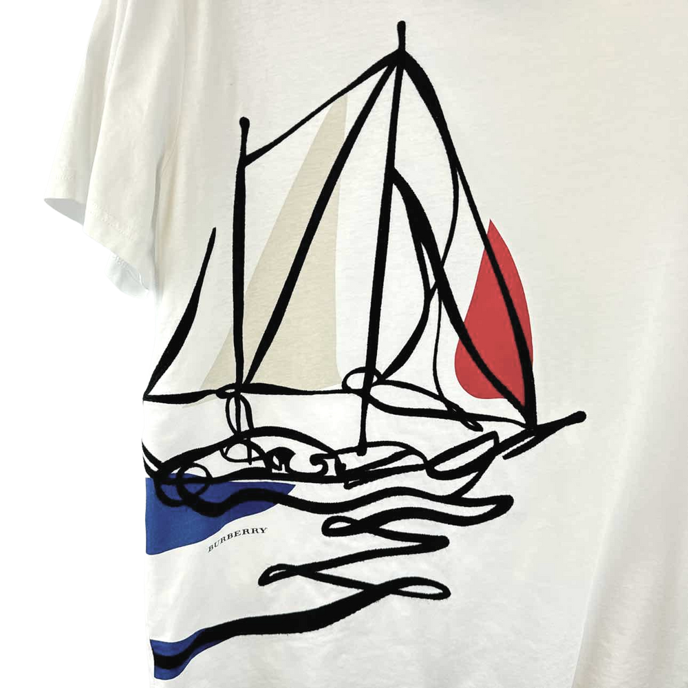 a white t - shirt with a picture of a sailboat