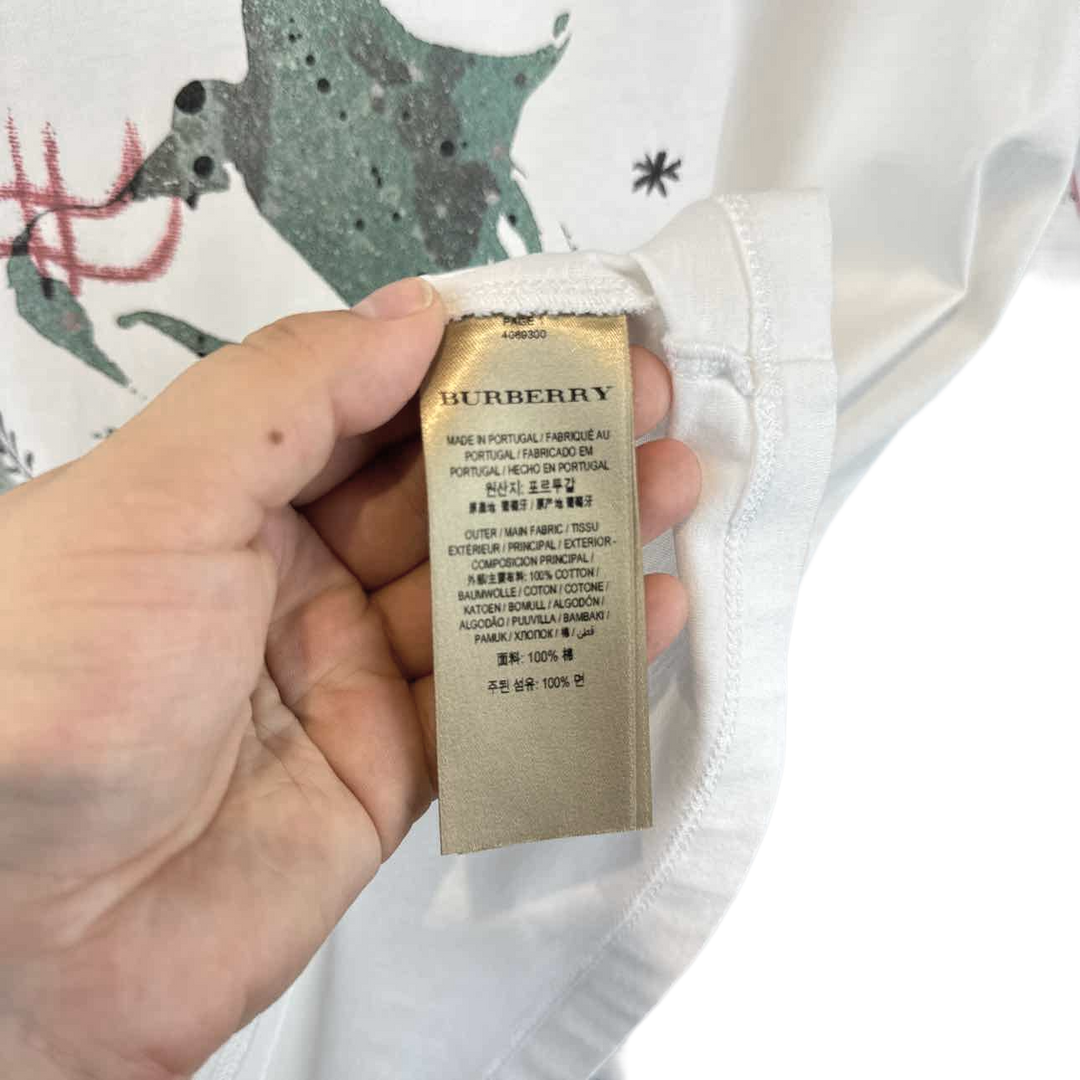 a person holding a label on a white shirt