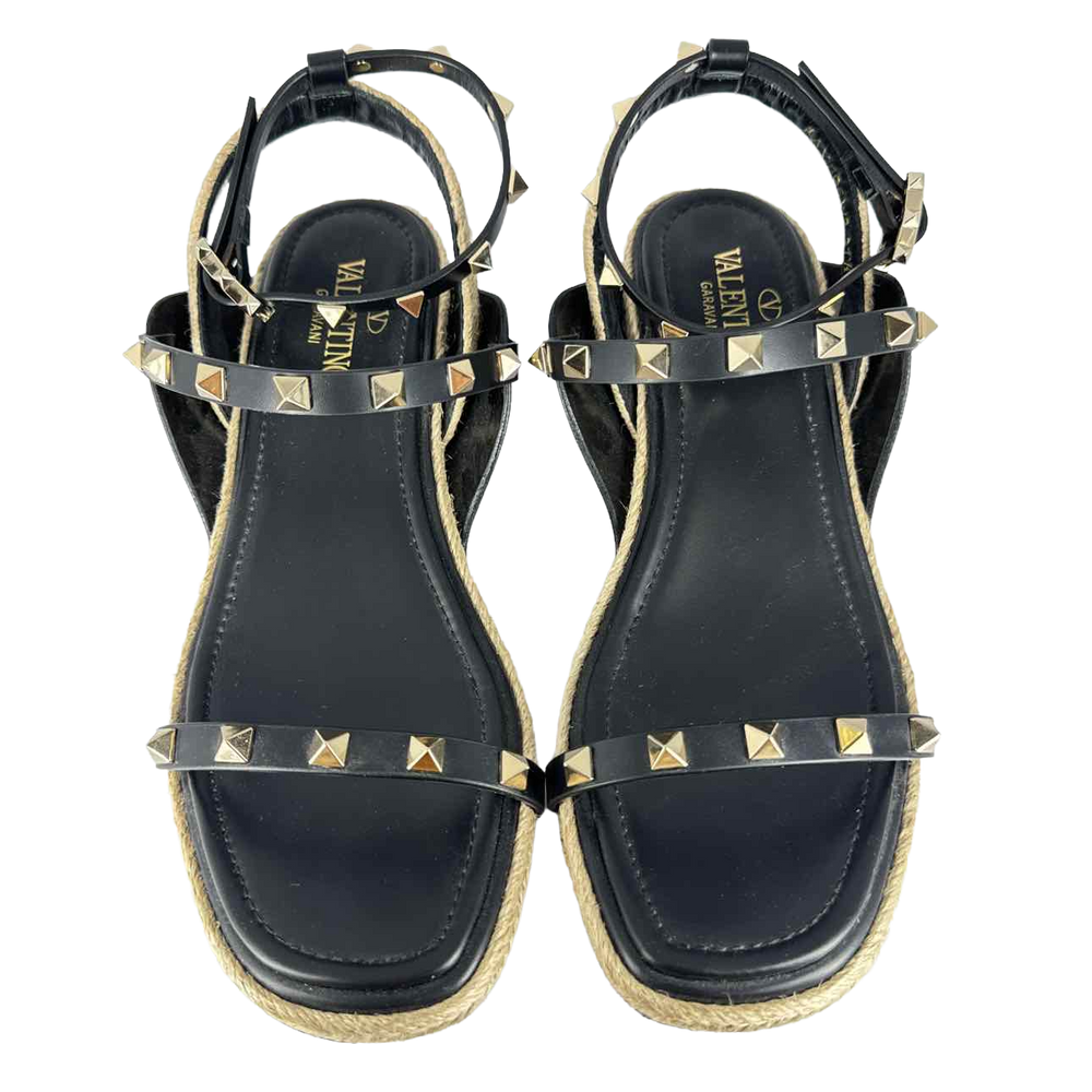 a pair of black and gold sandals